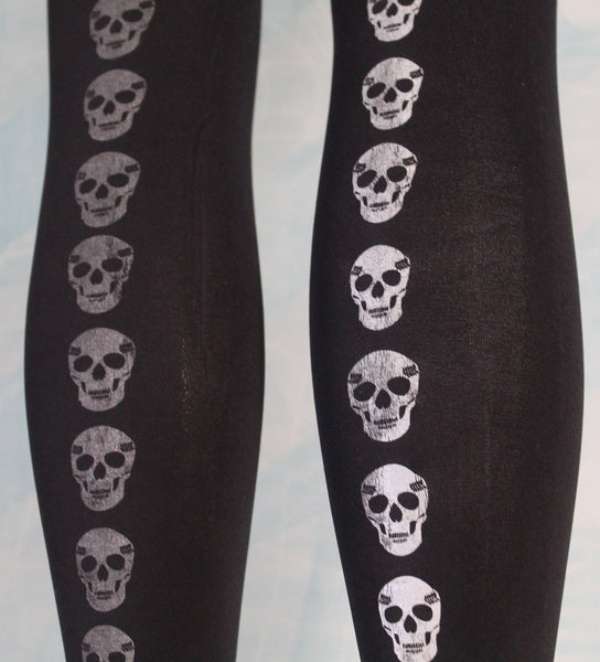 80 denier black footless tights, silver metallic printed skulls, close up of print